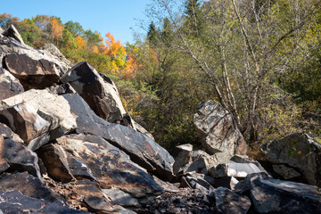 Cliffs in the mountains, autumn colors trees. Lake Isyk, Kazakhstan