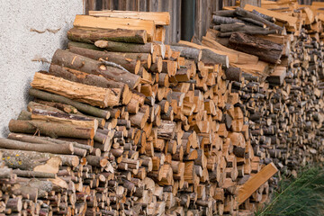 stacked firewood on the house wall for the winter