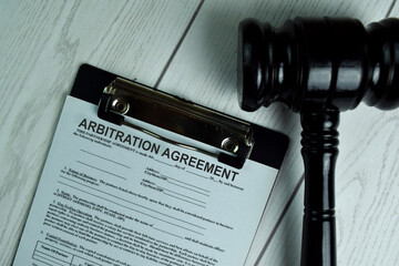 Arbitration Agreement Document form and Black Judges gavel on office desk. Law concept