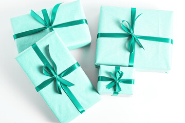 beautiful turquoise gift boxes decorated with a satin ribbon on a white background. minimalistic...