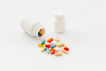 Heap of pills with drug bottle close up