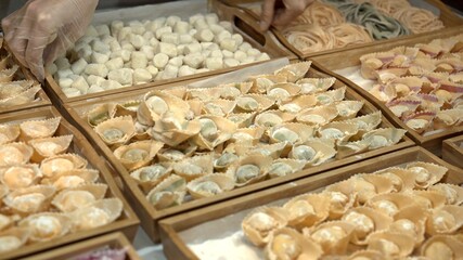 Tortellini on wooden trays at the italian restaurant kitchen, handmade italian food cooked. Lots of different tortellini prepared for restaurant meals