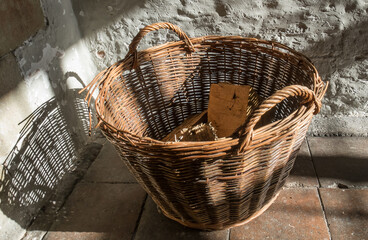Wood basket, white walls, bright sunlight 