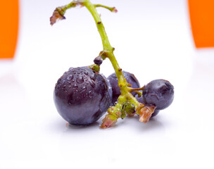 Close-up of red grape on white background