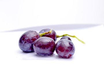 Close-up of red grape on white background