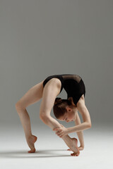 Young gymnast girl stretching and training