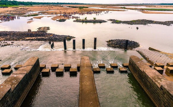 View of Durgapur Barrage and  Indian Hindu people doing "Tarpan", a  Faithfuls offer  to the divine for the liberation of the soul of their deceased elders .