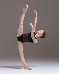 Young gymnast girl stretching and training