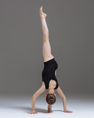 Young gymnast girl stretching and training