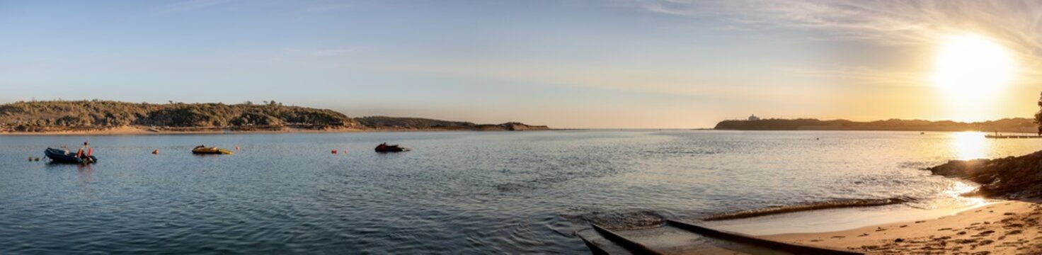 Wide panoramic image of river and sea in Alentejo with wonderful sunset with the sun in the image