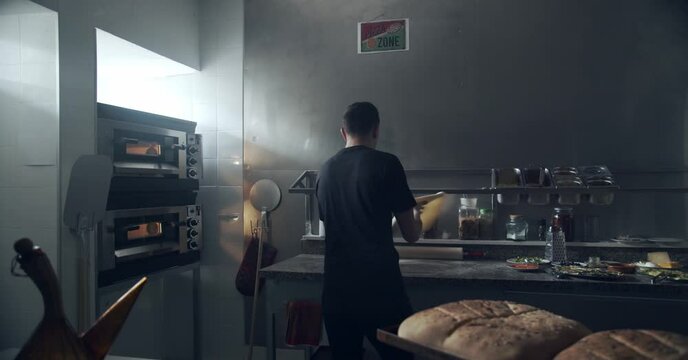 Anonymous chef stretching dough for pastry