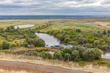 View  in early autumn from the high Bank at the confluence of the Toima river and Kama river ....