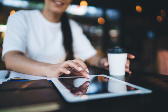 Cropped image of caucasian woman using digital tablet sending text messages and communicating online, selective focus on female using touchpad communicating and share content in blog