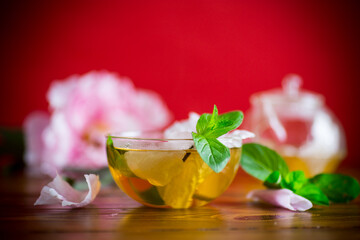 summer flower tea from rose petals in a glass teapot