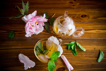 summer flower tea from rose petals in a glass teapot