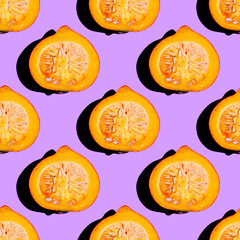 Creative seamless food pattern of halved orange pumpkin on neon purple background. Conceptual modern photography collage