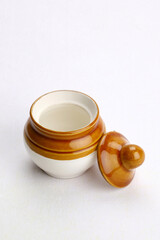 Isolated Indian traditional pickle jar in white background.