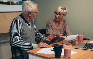 Mature couple doing finance at home stock photo