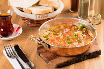 Traditional turkish breakfast food menemen made by eggs and tomatoes.