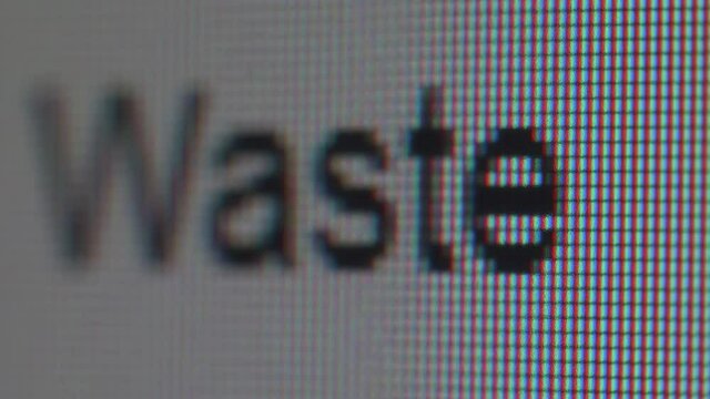 Close up view of typing the phrase about wasting time and money