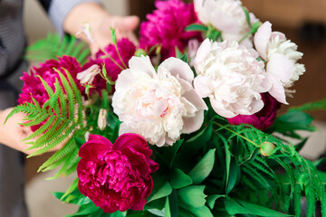 Bouquet of white and red peonies. Bright large flowers.