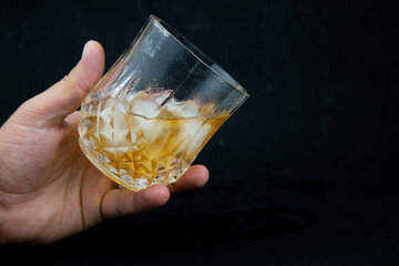 hand holding a glass of whiskey
