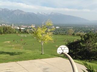 Beautiful park with mountains in the background, basketball hoop in foreground