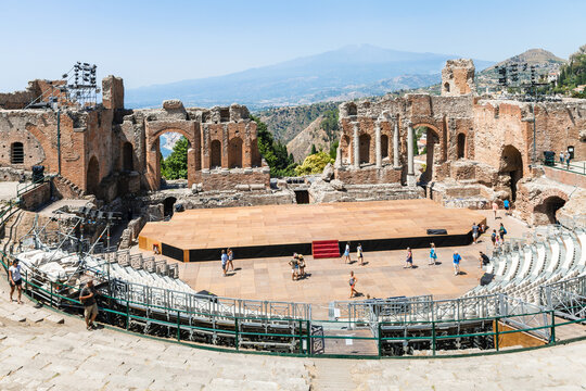 TAORMINA, ITALY - JUNE 29, 2017: Teatro antico di Taormina, ancient Greek Theater (Teatro Greco) and view of Etna mount in summer day. The amphitheater was built in the third century BC