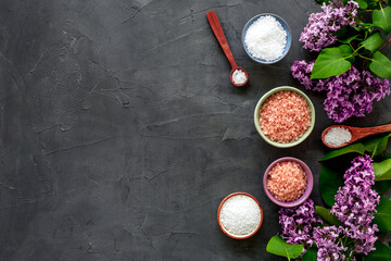 Sea salt spa set with pink lilac flowers. Top view