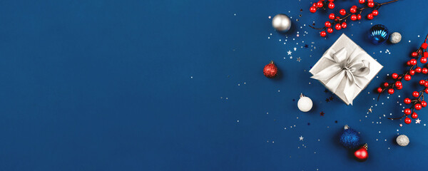 Blue Christmas background of gift box and decorations. The concept of the winter holidays. Flat lay, top view, copy space.