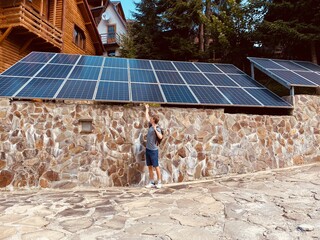 solar panels on the roof in the sun and guy installation. alternative energy