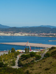 port of bilbao with ships and containers. you can see some industry and the sea as well as boats