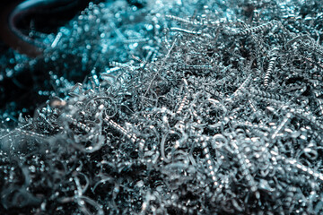 A pile of metal spirals as burr waste in metal processing.