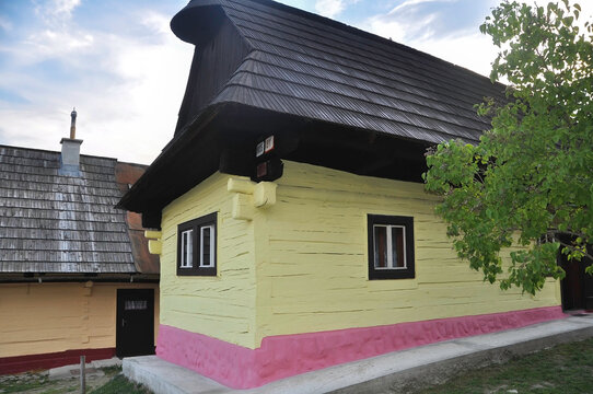 VLKOLINEC, SLOVAKIA, EUROPE, SUMMER 2015. Beautiful rural house with traditional Slovak vanilla painted wooden architecture in the Unesco heritage village of Vlkolinec.