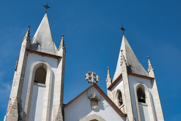 top of a white church with two towers