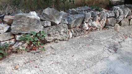 Hand-set wall of stones in a narrow street 