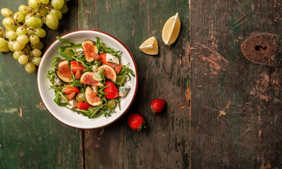 vegetarian salad with rucola, figs, blue cheese, strawberries, grapes, Long banner format. space for text