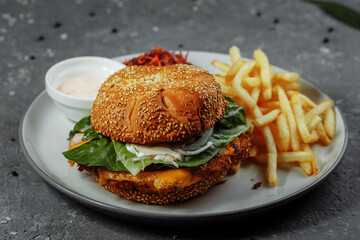 Fresh and fried fish burger with vegetables