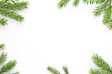 Christmas frame with fir tree branches at white background. Christmas flat lay with space for text.