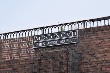 Iron Name Plate & Roman Numerals on Brick Wall of English Canal Viaduct 