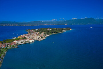 An ancient village on southern Garda Lake. Aerial view on Sirmione sul Garda. Italy, Lombardy. View by Drone. Aerial view at high altitude. Rocca Scaligera Castle in Sirmione.