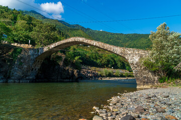 Fototapeta na wymiar The stone arch bridge over the Ajaristskali river, Dandalo bridge, Georgia