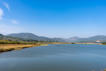 Awesome view of small lake  near a greenery mountain background.
