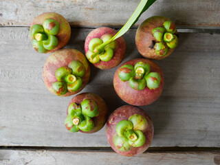 Mangosteens on wooden background