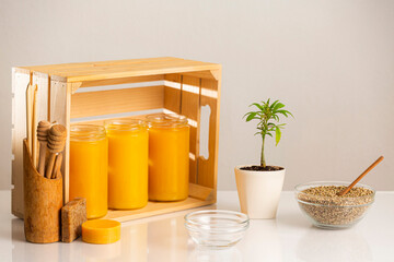 Jars of CBD honey, marijuana plant and hemp seeds
