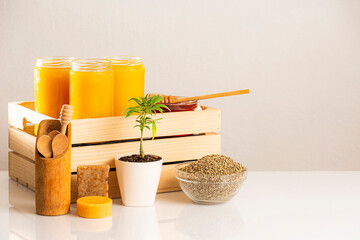 Jars of CBD honey, marijuana plant and hemp seeds