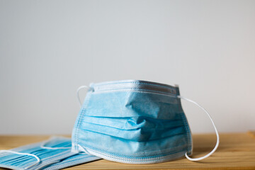 Surgical masks on a neutral wooden or white background to prevent the new covid-19 disease