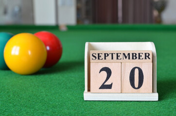 September 20, number cube with balls on snooker table, sport background.