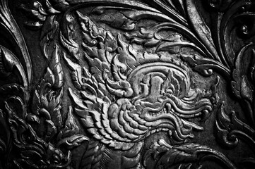 Closeup Beautiful Thai pattern carving lotus picture at door in temple.