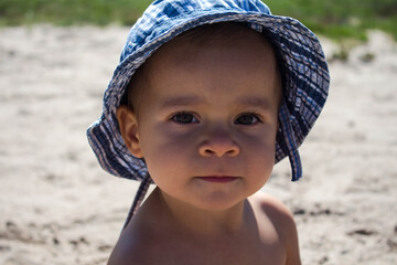 a portrait of a beautiful child against a background of yellow sand
